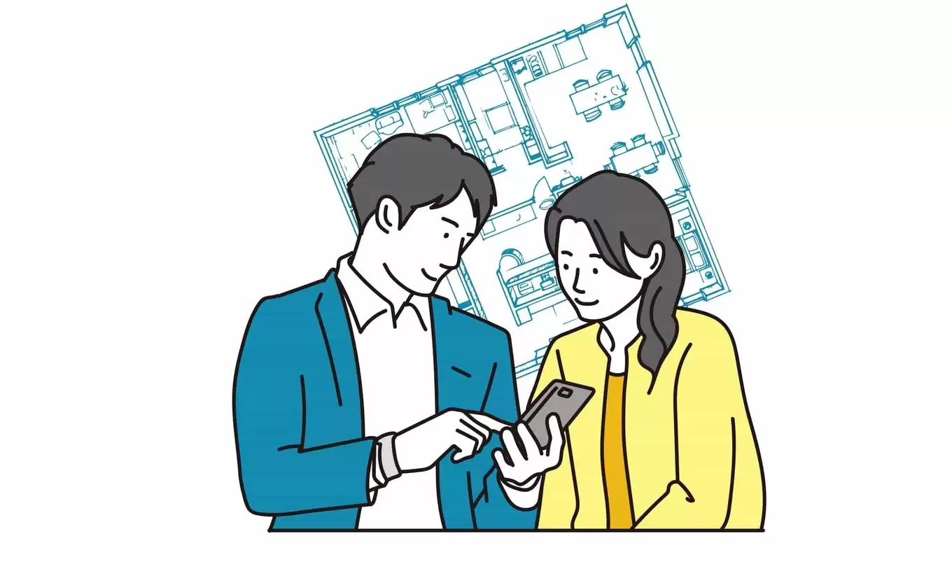 スマートフォンで不動産物件を見る夫婦