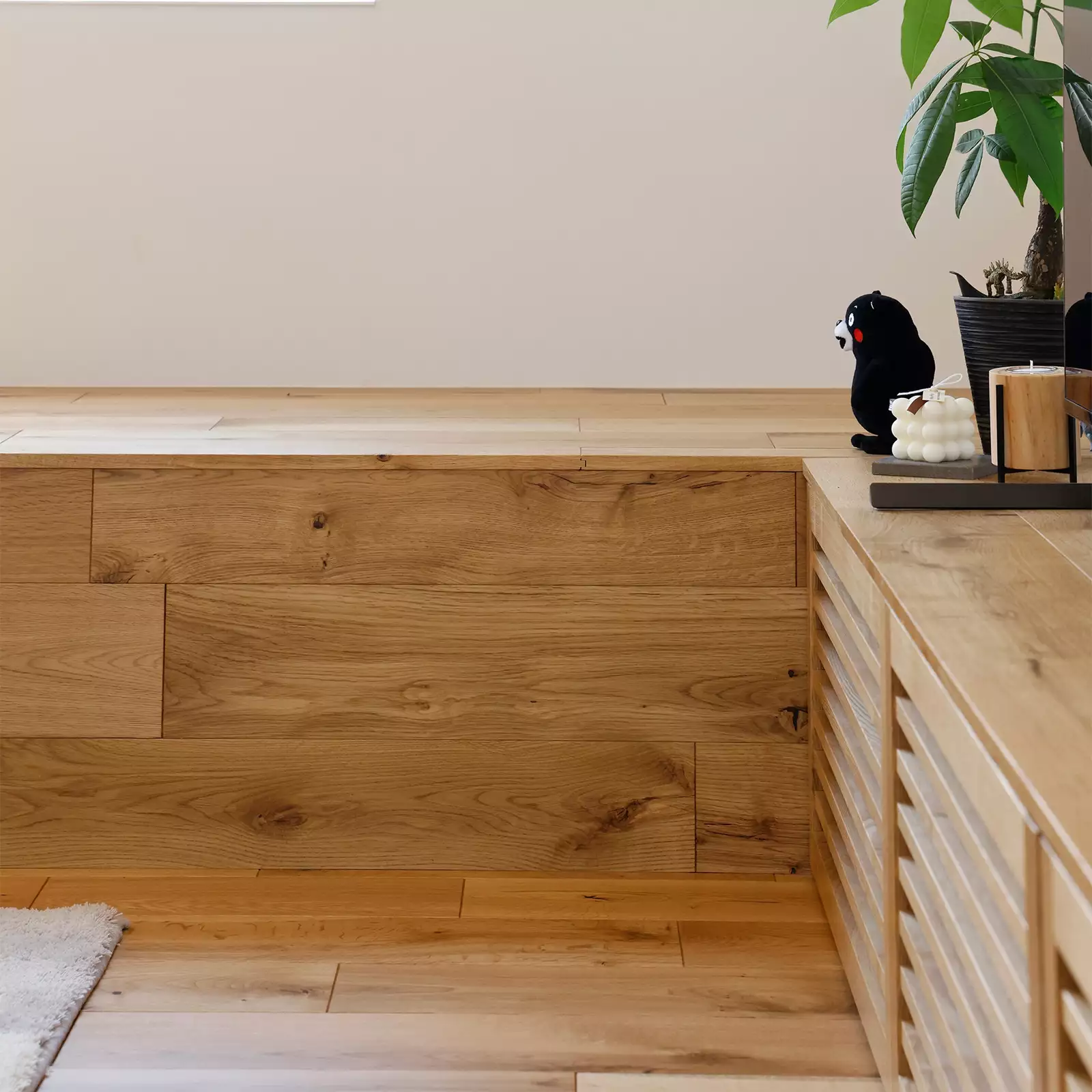 R+houseの物件のLDKにあるベンチの写真。床材と同じ素材を使ったベンチはくつろぎの空間。